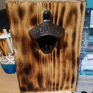 Wall bottle opener with cap collection bin.